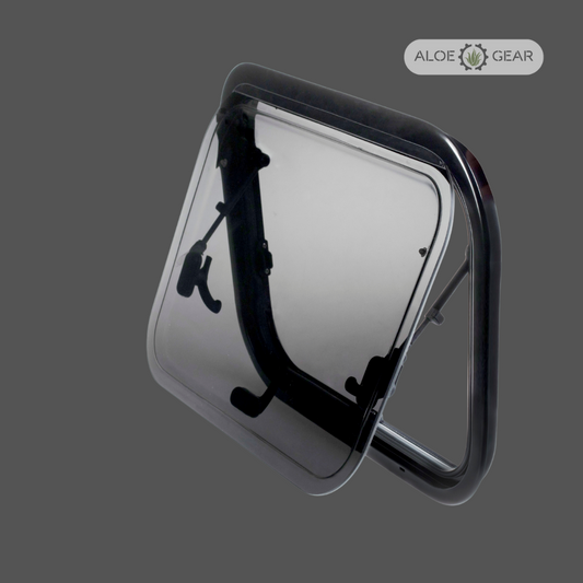 Motorhome or caravan window with black frame and clear flap on a gray background, branded 'Aloe Gear'.