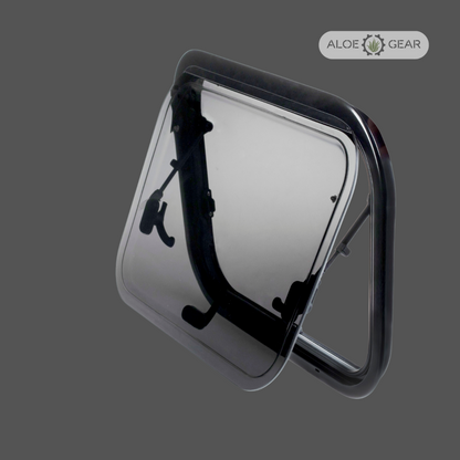 Motorhome or caravan window with black frame and clear flap on a gray background, branded 'Aloe Gear'.